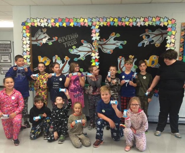 Students show off their new stickers as part of Autism Awareness Month activities