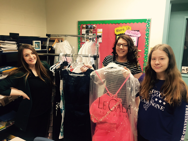 Students take a look at recent donations (in photo: L-R: Ms. Laura Gushue, Toni-Marie Adams, Lily Tucker)