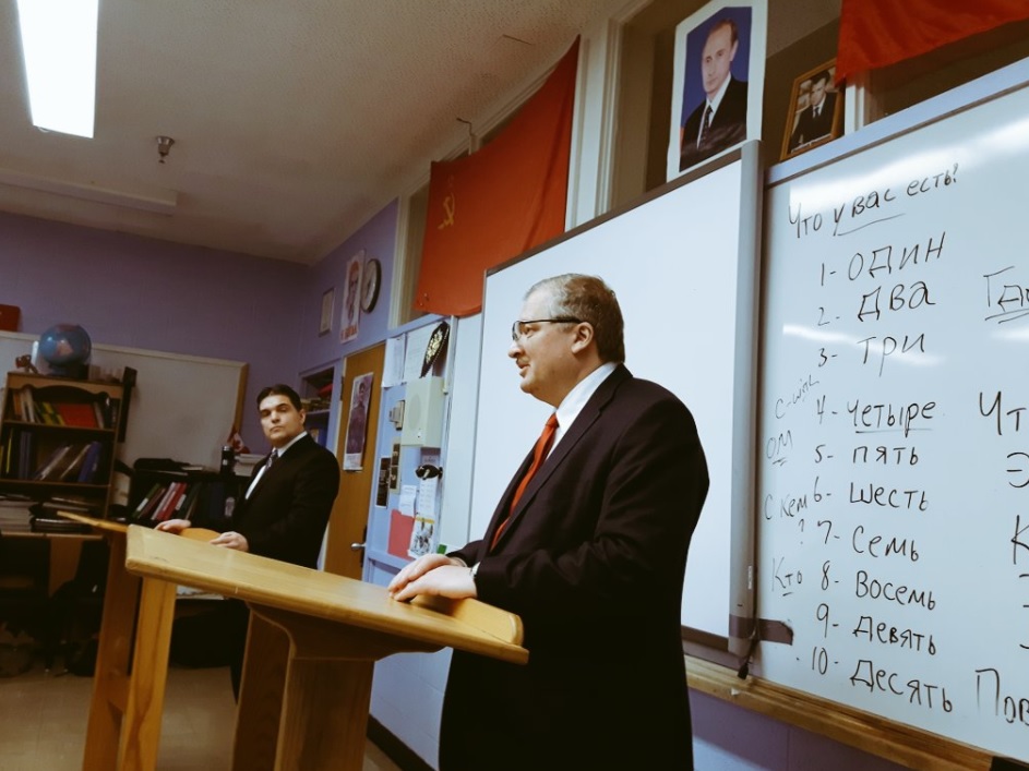 Teacher Rod Squires (R) introduces Russian Ambassador Alexander Darchiev to his PWC students. 