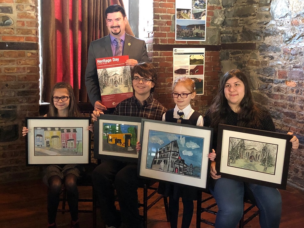 Minister Christopher Mitchellmore poses with this year's poster contest winners at an event at the Yellowbelly in downtown St. John's
