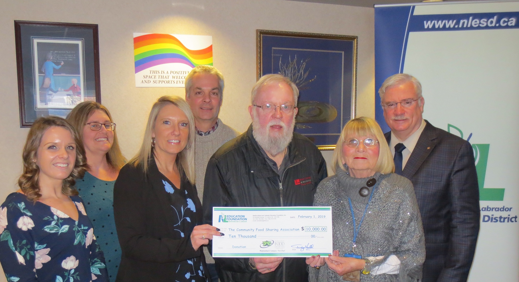 Staff representatives present the Community Food Sharing Association's Eg Walters with a cheque for $10,000 (photo credit: NLESD)