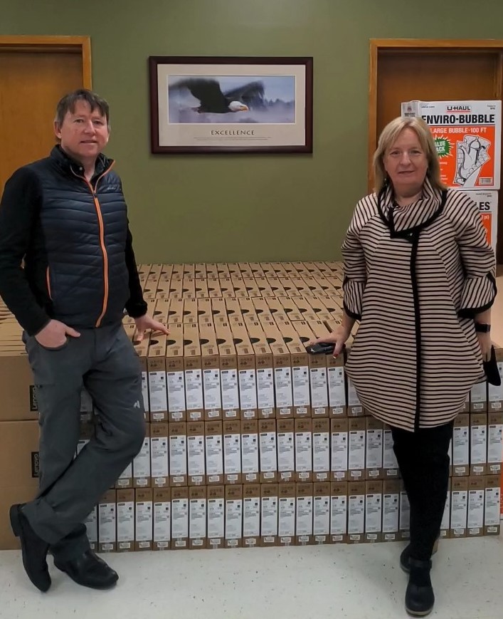 Board Chair Goronwy Price and Janet Wiseman, Director of Schools (Labrador region) check out the student Chromebooks which have arrived in Happy Valley-Goose Bay. They are being prepared for distribution to Labrador schools, beginning early next week. 